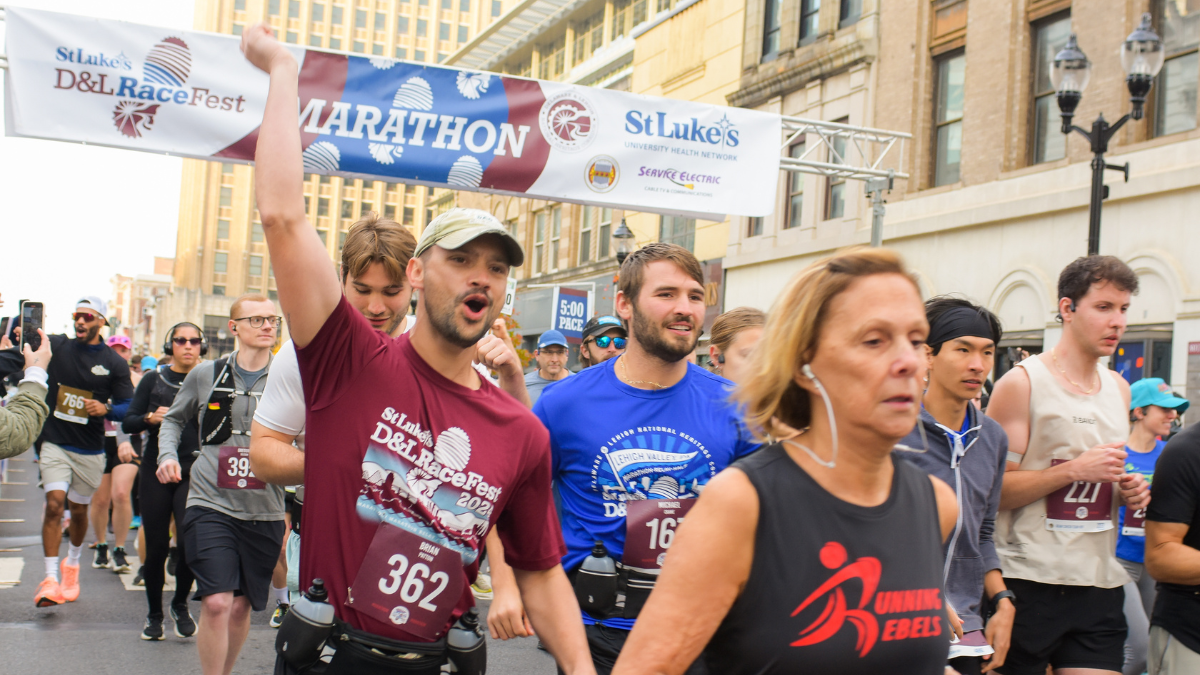 The starting line for the 2025 D&L RaceFest presented by St. Luke's with runners taking off from the starting line.